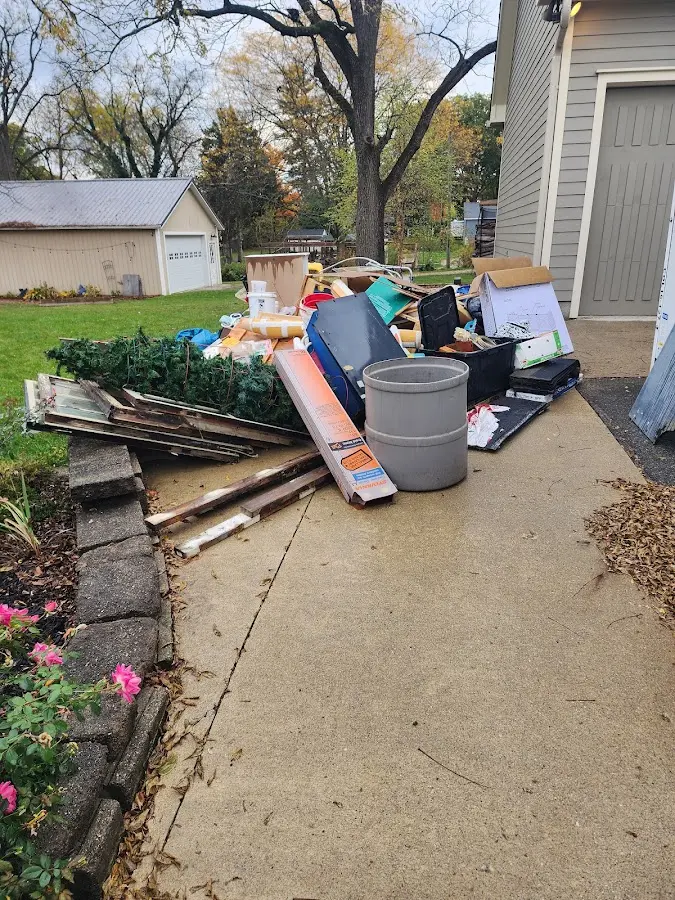 Dumpster being loaded with debris for Roofing Dumpster Rental in Van Buren